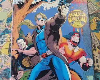 May include: A comic book cover featuring a group of three men in a forest setting. The cover is titled "Blaze" and features the text "Apache Autumn Part Two of Three". The main character is a man with a blue shirt and brown jacket, holding a gun. The other two men are wearing red and black clothing. The comic book is from December 1993 and is issue number 5.