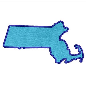 May include: A light blue embroidered patch in the shape of the state of Massachusetts, with a dark blue outline. The patch has a textured appearance and is set against a white background.