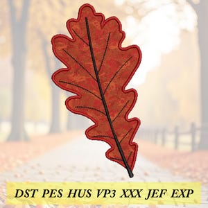 May include: A detailed, embroidered oak leaf in shades of red and orange, with a black central vein and outline. The leaf design is set against a blurred autumn background. The text "DST PES HUS VP3 XXX JEF EXP" is at the bottom.