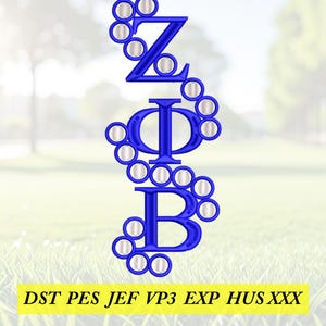 May include: A blue embroidered design featuring the Greek letters ZΦB, with decorative circles. The letters are vertically aligned. The image includes the text "DST PES JEF VP3 EXP HUS XXX" in a yellow rectangle at the bottom.