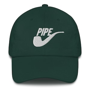 May include: A dark green baseball cap with a white embroidered design of a pipe with the word "PIPE" above it.
