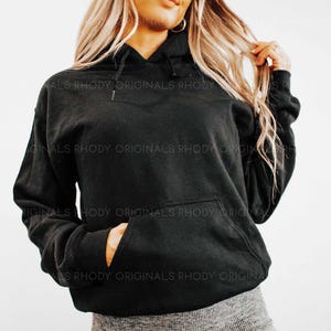 May include: A black hooded sweatshirt with a kangaroo pocket. The sweatshirt has the text "ALS RHODY ORIGINALS RHODY" printed on it.