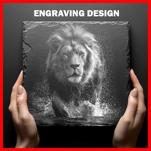 May include: Black and white engraved slate featuring a majestic lion walking through water. The image is detailed, showing the lion's fur and the water's splash. The words "ENGRAVING DESIGN" are at the top. The slate is held by two hands.