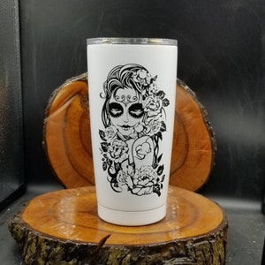 Sandblasted Sugar Skull with peonies on a 18.5 ounce insulated stainless steel tumbler