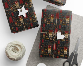 May include: Wrapping paper with a black background featuring a repeating pattern of red wrestling singlets, yellow lightning bolts, stars, dumbbells, and cartoon shaker bottles with angry faces, tied with twine and white star or heart tags.