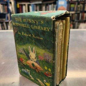 May include: A set of four small, colourful books titled "The Bunny's Nutshell Library" by Robert Kraus. The books are bound in yellow and green paper with illustrations of a bunny rabbit and other animals.