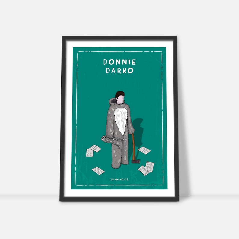 May include: A teal green poster with a black frame featuring a cartoon illustration of a man in a grey rabbit costume holding an axe. The text "DONNIE DARKO" is at the top of the poster. There are several pieces of paper scattered around the man.