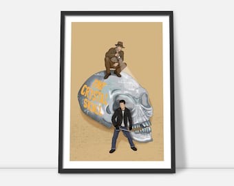 May include: A framed poster with a beige background featuring a silver skull with the text "The Crystal Skull" in orange. Two figures are standing on the skull, one in a brown jacket and fedora, the other in a black leather jacket.