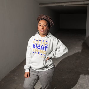 May include: A white hooded sweatshirt with the text "Did the Right Thing" in gold and blue lettering. The text is surrounded by a pattern of gold and blue triangles.