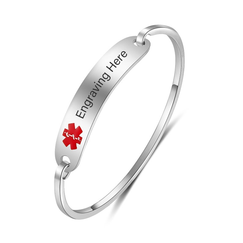 May include: A silver medical alert bracelet with a red medical symbol and the text "Engraving Here".