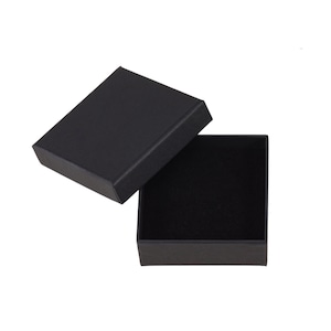 May include: A black square-shaped gift box with a lid open. The box is lined with black velvet.