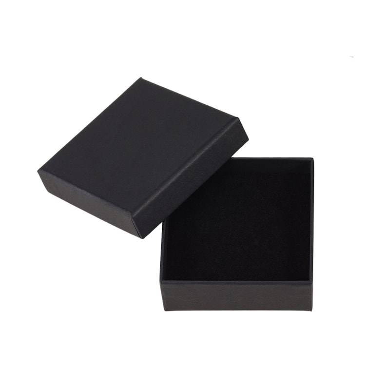 May include: A black square-shaped gift box with a lid open. The box is lined with black velvet.