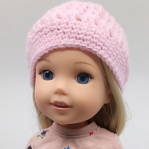 May include: A pink crocheted hat with a simple design. The hat is made with a soft yarn and has a comfortable fit.