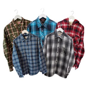 May include: Five plaid button-down shirts in various colors, including green, blue, and red, hanging on white hangers. The shirts have long sleeves and are made of a flannel-like material. The shirts are displayed against a white background.