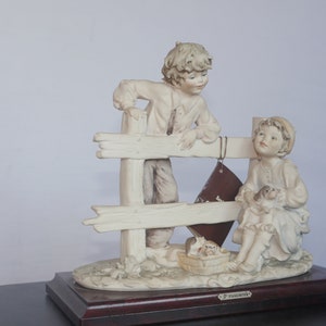 lot nr 330 vintage G Armany statue of boy and girl with small puppy dogs Florence 1983 signed B Merli, with book