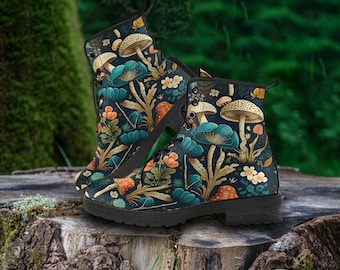 May include: A pair of black combat boots with a whimsical mushroom and floral pattern. The boots feature a dark teal background with orange, teal, and beige mushroom and floral designs. The boots are displayed on a tree stump.