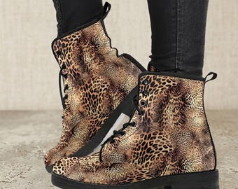 May include: A pair of ankle-high boots with a leopard print pattern. The boots have black laces, a black sole, and a small heel. The leopard print features shades of brown and tan.