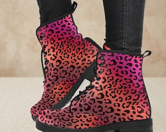 May include: Combat boots with a vibrant leopard print in shades of pink, orange, and black. The boots have a lace-up design with black laces and a black sole. The boots are ankle-high.