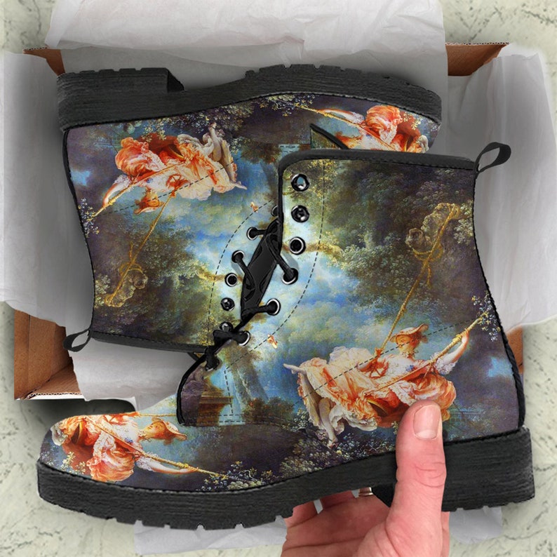 Side profile view of boots showing lace-up closure, boot height, and design details