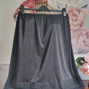 Black half slip in nylon edged in lace with elasticated waist, by BHS, vintage slip, 60s 70s