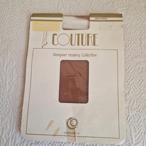May include: A package of Couture Designer Hosiery Collection tights. The package is white with a rectangular window showing the tights. The text "COUTURE" is printed in a stylized font. The package is marked "Made in England."