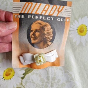 1950s hair slide by Milady, The Perfegt Grip, Bow and Flower hair grip in ivory and primrose yellow,  deadstock on original card