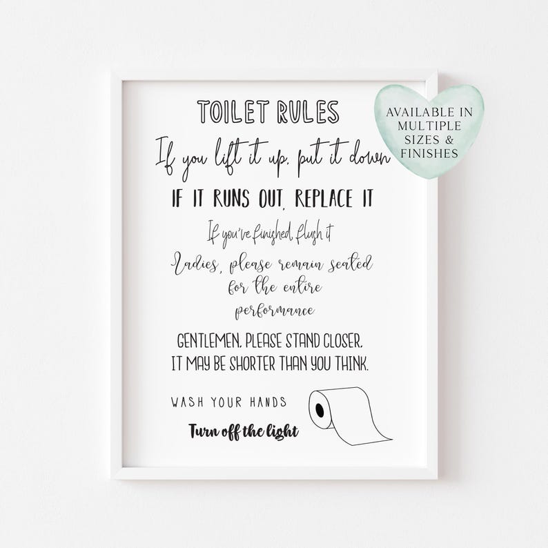 May include: A framed white print with black text that reads "TOILET RULES" followed by humorous instructions. A heart-shaped graphic states "AVAILABLE IN MULTIPLE SIZES & FINISHES". A roll of toilet paper is illustrated.