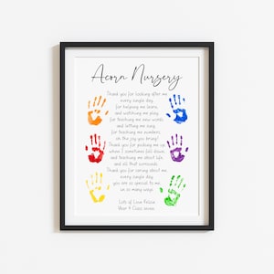 May include: Framed print with the text "Acorn Nursery" and a poem, featuring colorful handprints. The print includes the text "Lots of Love Kelsie, Year 4 Class seven". The frame is black.
