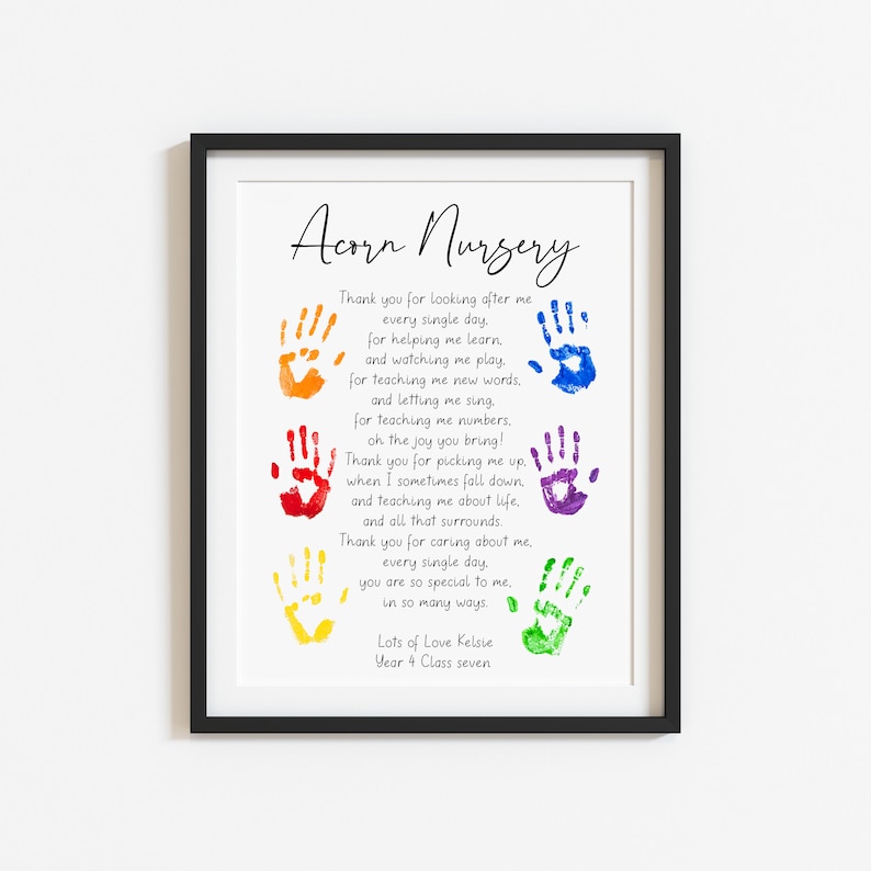 May include: Framed print with the text "Acorn Nursery" and a poem, featuring colorful handprints. The print includes the text "Lots of Love Kelsie, Year 4 Class seven". The frame is black.