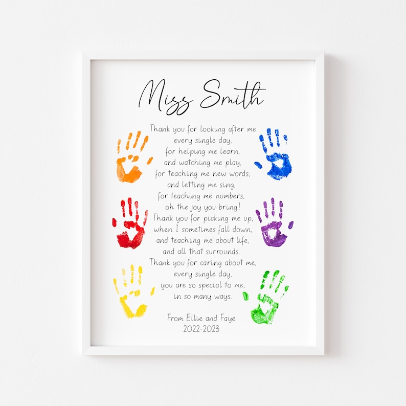 May include: A framed print with a white border features a poem and colorful handprints. The text reads "Miss Smith" at the top, followed by a thank you message and the names "Ellie and Faye" with the year "2022-2023" at the bottom.