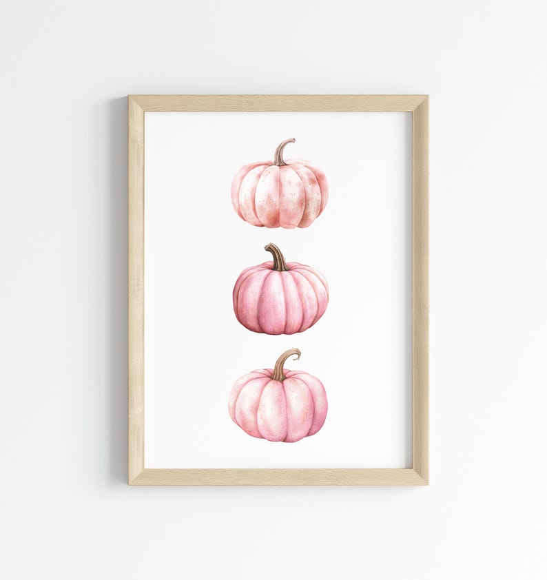 K&ouml;nnte beinhalten: Gerahmter Druck mit drei rosa Aquarellk&uuml;rbissen. Jeder K&uuml;rbis hat einen Stiel und ist vor einem wei&szlig;en Hintergrund platziert. Die K&uuml;rbisse sind vertikal angeordnet und bilden eine einfache, elegante Komposition.