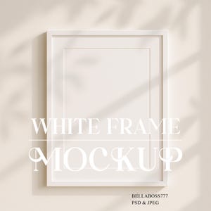 May include: White frame mockup on a light beige wall with shadows from a window. The frame is empty and ready for your design.