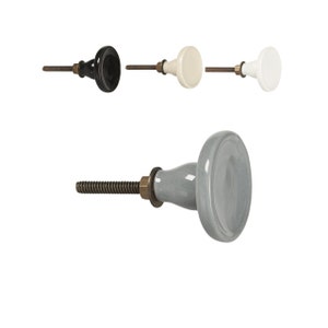 Könnte beinhalten: Vier Keramik-Schrankknöpfe mit einer Schraube. Die Knöpfe sind in Schwarz, Weiß, Cremeweiß und Grau.