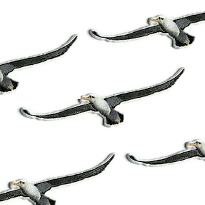 May include: Five black and white embroidered iron-on patches of albatross birds in flight.