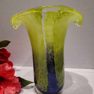 May include: A green and blue glass vase with a wide, flared opening and a textured surface.