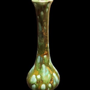 May include: A tall, slender ceramic vase with a bulbous base and flared rim. The vase features a glossy glaze in shades of green, brown, and gold, with a dripped effect. The vase is approximately 10 inches tall.