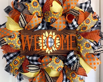 Fall front door wreath welcome sunflower with buffalo plaid; orange, yellow, and plaid; thanksgiving; autumn; pumpkins; farmhouse wreath