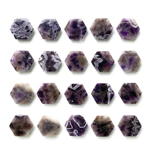 May include: Twenty amethyst hexagonal stones arranged in a grid pattern on a white background. The stones are a deep purple color with white veins running through them.