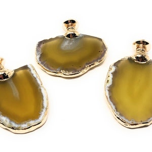 May include: Three agate drawer pulls with gold trim. The agate is a light yellow color with white and gray banding. The pulls are attached to a gold metal base.