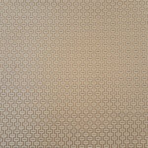 May include: A close-up of a beige fabric with a woven pattern of small, dark brown squares.