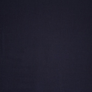 May include: A solid dark blue fabric background.