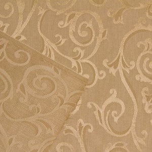 May include: A close-up of a beige fabric with a repeating pattern of swirling, embossed designs. The fabric has a subtle sheen and a textured surface.