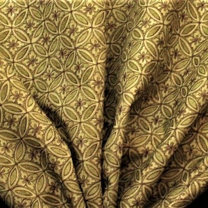 May include: Green and brown fabric with a repeating pattern of overlapping circles and flowers.