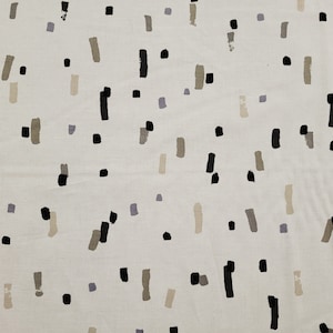 May include: White fabric with a repeating pattern of black, brown, and gray brushstrokes. The brushstrokes are in various sizes and shapes.