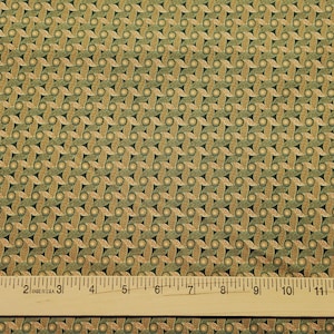 May include: Green and gold fabric with a repeating pattern of interlocking circles and leaves.