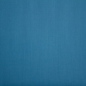 May include: A solid blue fabric background.