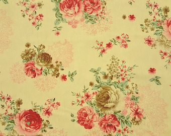 May include: A yellow fabric with a floral pattern featuring pink and red roses, green leaves, and small pink flowers.