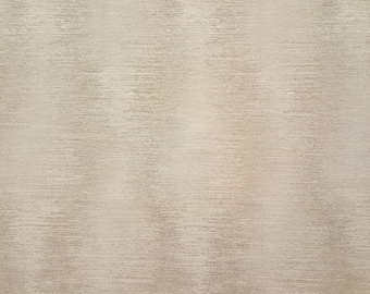 May include: A close-up of a textured, beige fabric with a subtle, horizontal pattern. The fabric has a slightly metallic sheen, creating a soft, shimmering effect. The overall appearance is neutral and versatile.