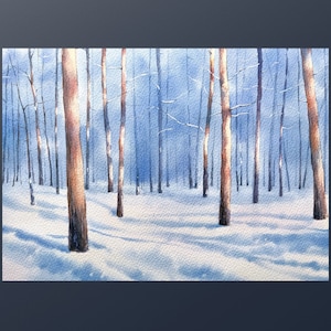 May include: A watercolor painting of a snowy forest scene with tall, bare trees in the background. The trees are painted in shades of blue and brown, and the snow is a light blue color. The painting has a soft, dreamy feel.