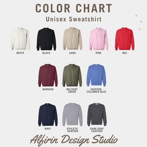 May include: Color chart showing different colors of unisex sweatshirts. The colors include white, black, sand, pink, red, maroon, military green, heather columbia blue, navy, athletic heather, and dark gray heather.